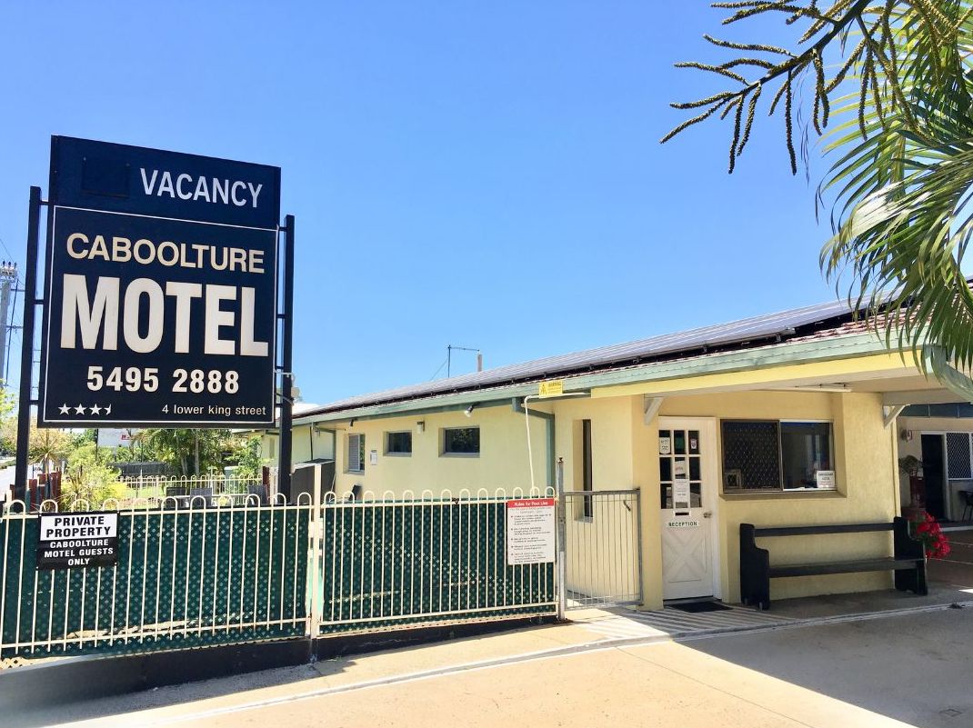 Caboolture Motel exterior at street level showing reception entrance and on-site parking