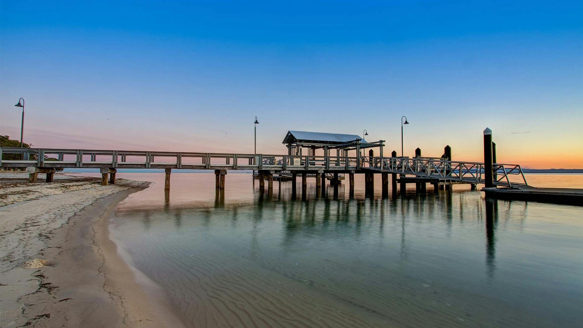 bribie-island-in-a-day Calm bay water and white sand at Bongaree Beach on Bribie Island, a day trip from Caboolture